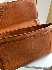 saddle brown whipstitch flapover crossbody bag